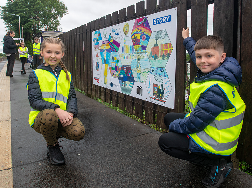 Mural made by local school children welcomes passengers to Mills Hill station